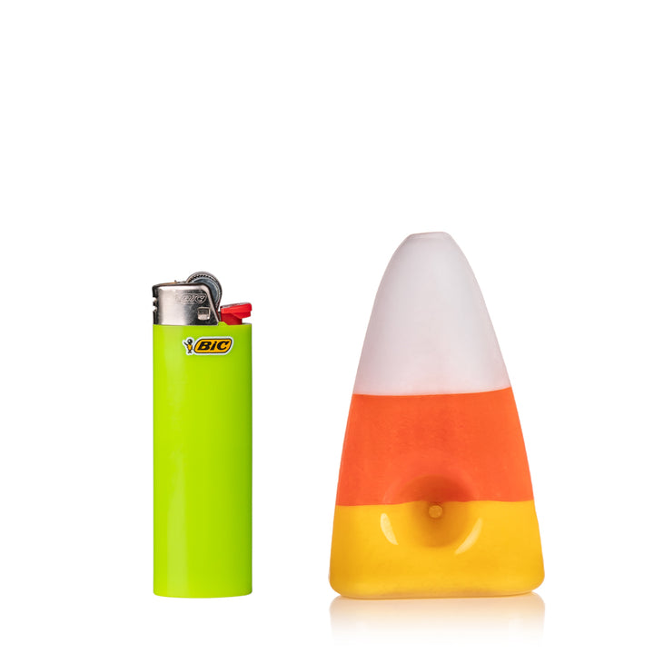 MJ Arsenal Candy Corn Pipe displayed next to lighter for size comparison, 3.5-inch compact Halloween glass pipe