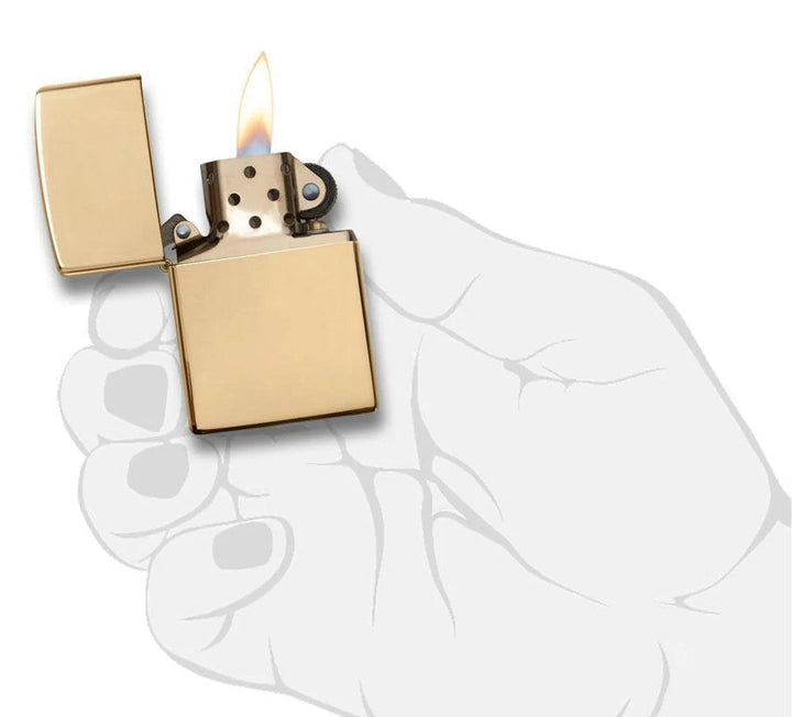 Zippo Brass windproof lighter with high polish finish shown lit, held in illustrated hand. Durable, refillable, and ideal for everyday use or gifting.