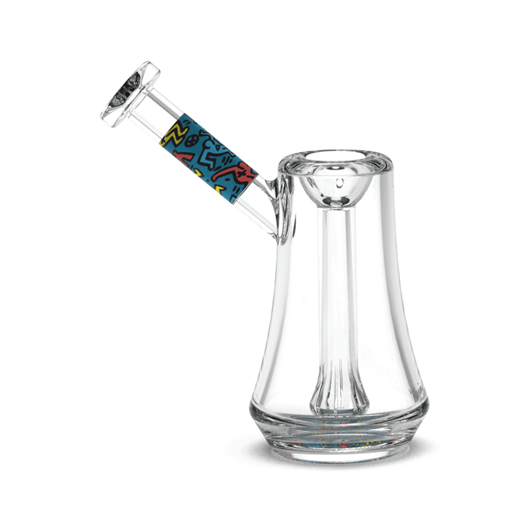 Keith Haring Glass - Bubbler - Multi Blue water pipe featuring bold pop art design on the neck and a sleek, clear glass body for smooth smoking.