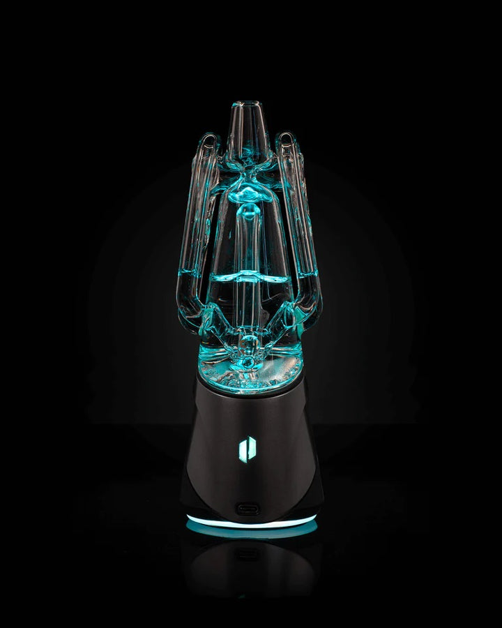 Puffco Ryan Fitt Recycler Glass 2.0 – illuminated in blue light showing refined glass engineering and recycler pathways.