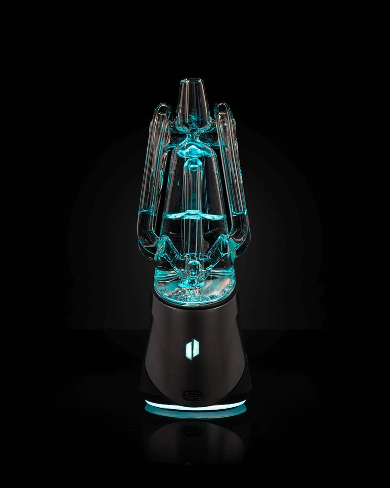 Puffco Ryan Fitt Recycler Glass 2.0 – illuminated in blue light showing refined glass engineering and recycler pathways.